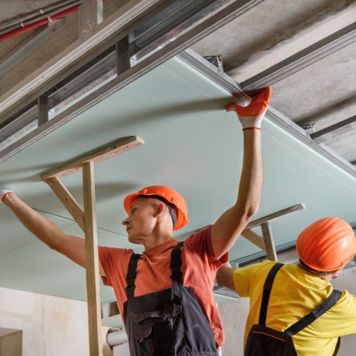 two worker are installing ceiling